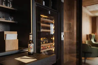 a bottle of beer sitting on a table in a bar at Luxury B&B August in Ortisei