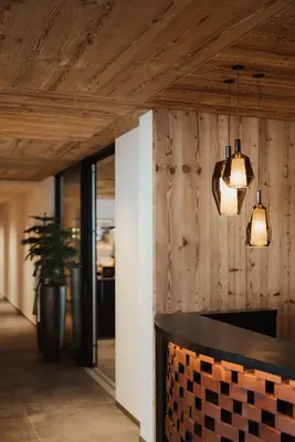 a kitchen with two lights hanging from a ceiling at Luxury B&B August in Ortisei
