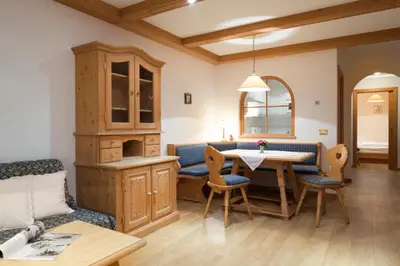 a living room with a couch and a table at Residence La Selva in Selva di Val Gardena
