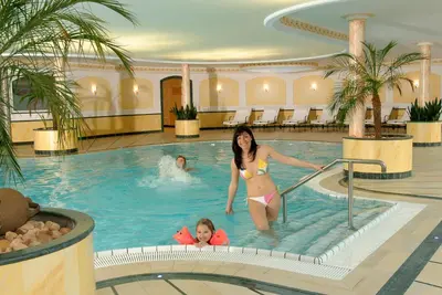 a woman and a child in a swimming pool at Residence Isabell in Selva di Val Gardena