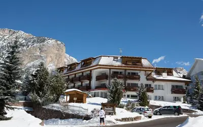 a hotel in the mountains with snow on the ground at Residence Isabell in Selva di Val Gardena