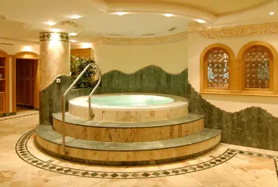a large bathroom with a jacuzzi tub in a building at Residence Isabell in Selva di Val Gardena
