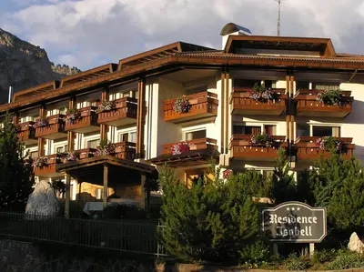 a large building with balconies and flowers on it at Residence Isabell in Selva di Val Gardena