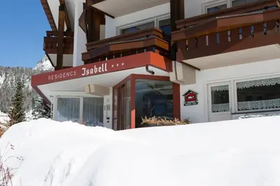 a snow pile in front of a building at Residence Isabell in Selva di Val Gardena
