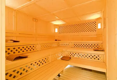 a sauna with wooden shelves and a wooden floor at Residence Villa Gran Baita in Selva di Val Gardena