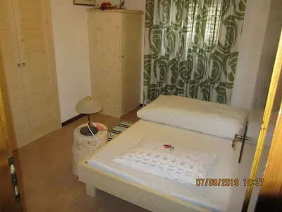 a small room with a bed and a table at Ciesa Dei Maestri in Sottoguda