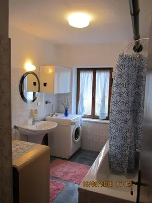 a bathroom with a sink and a shower curtain at Ciesa Dei Maestri in Sottoguda