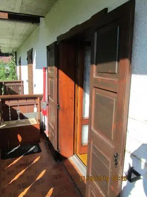 an open wooden door in a room with at Ciesa Dei Maestri in Sottoguda