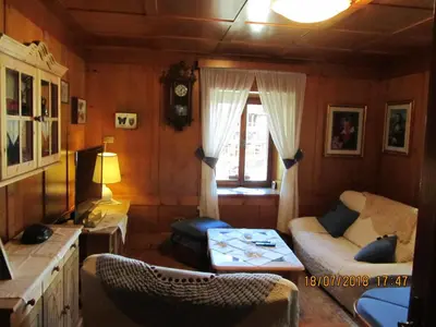 a living room with a couch and a window at Ciesa Dei Maestri in Sottoguda