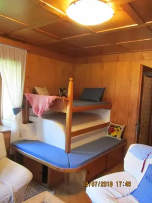 a bedroom with three bunk beds in a room at Ciesa Dei Maestri in Sottoguda