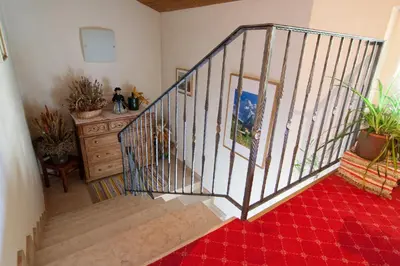 an overhead view of a staircase with potted plants at Pension Enzian in Badia