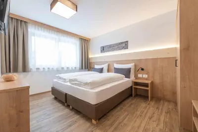a bedroom with a large bed and a window at Residence Lersc in Badia