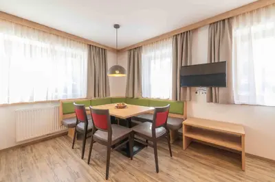 a dining room with a table and chairs at Residence Lersc in Badia