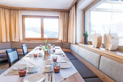 a dining room with a long table and a window at Residence Lersc in Badia