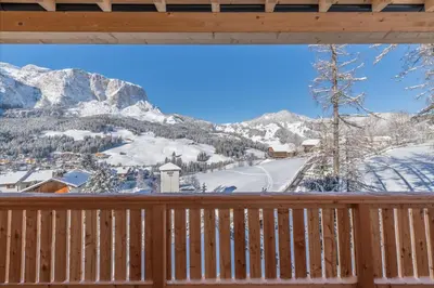 a view from the deck of a cabin with snow covered mountains at Residence Lersc in Badia