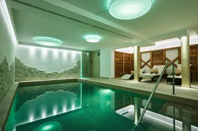 a house with a swimming pool in the middle of it at Hotel Garni Savoy - new opening in Castelrotto