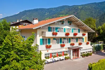 a building with flowers on the balconies of it at Parkhotel Plauserhof in Plaus