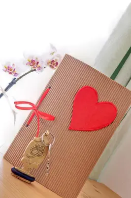 a card with a heart and a pair of scissors at Parkhotel Plauserhof in Plaus
