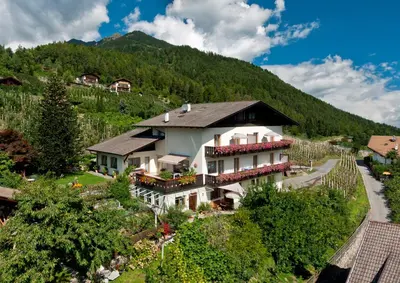 an aerial view of a house with a mountain at Sonnenhof in Rifiano