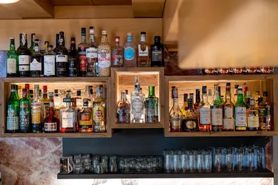 a bar filled with lots of bottles of alcohol at Hotel Gran Paradis in Campitello di Fassa