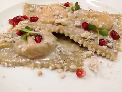 a piece of food on a white plate at Hotel Gran Paradis in Campitello di Fassa