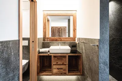 a bathroom with a sink and a mirror at Hotel Scherlin in Ortisei