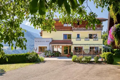 a house in the mountains with a driveway at Residence Schiestlhof in Naz-Sciaves