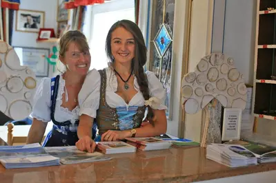 two women standing at a counter in a store at Hotel Chalet Alaska in Pozza di Fassa