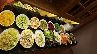 a counter with many bowls of different types of food at Pension Sonnenhof in Maranza