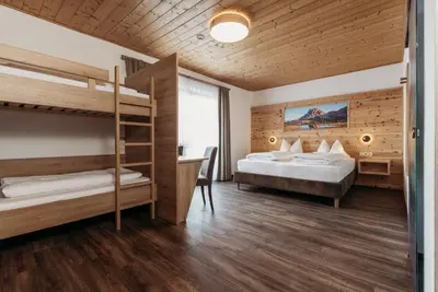 a bedroom with two bunk beds and a desk at Pension Sonnenhof in Maranza