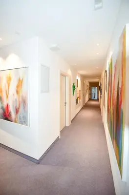 a hallway of an art gallery with paintings on the walls at Pension Martha in Postal