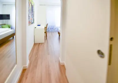 a room with a hallway with a hard wood floor at Pension Martha in Postal