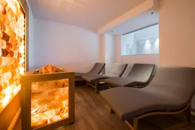 a row of chairs in a waiting room with a fireplace at Albergo Bucaneve in Malosco