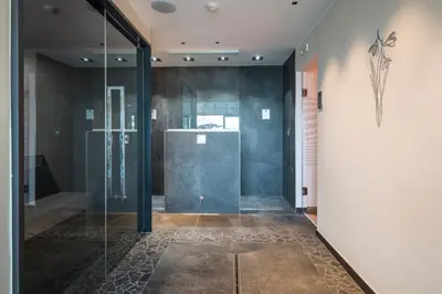 a glass shower door in a hallway with at Albergo Bucaneve in Malosco