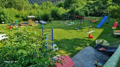 a backyard with a playground with a play set at Laimerhof in Rifiano