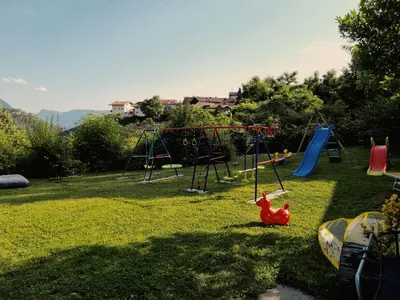 a park with a playground with a swing at Laimerhof in Rifiano