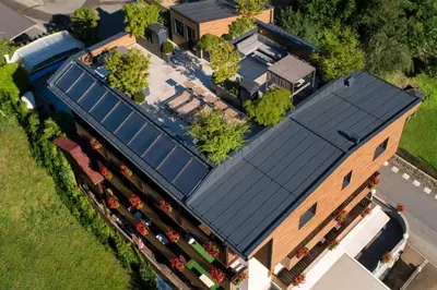 an overhead view of a building with a blue roof at Hotel Pension Sonnegg in Saltusio