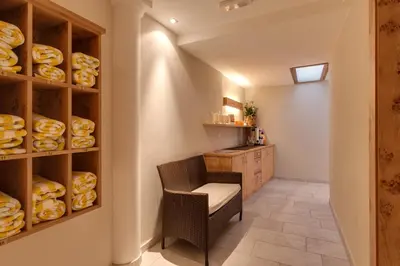 a small room with a chair and a table with bread at Hotel Pension Sonnegg in Saltusio