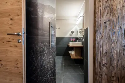 a bathroom with a shower and a sink at Hotel Pension Sonnegg in Saltusio