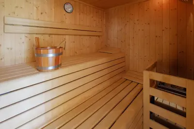 a wooden sauna with a bucket in it at Gasthof Löwen in Nova Levante
