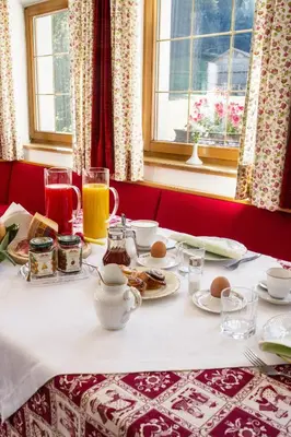 a table with food and drinks on top of it at Villa Insam in Selva di Val Gardena