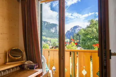 a window with a view of a mountain view at Villa Insam in Selva di Val Gardena