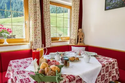 a table with a plate of food on it at Villa Insam in Selva di Val Gardena