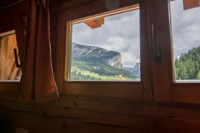 a window in a room with a view of a mountain at Villa Insam in Selva di Val Gardena