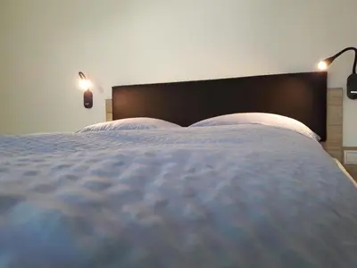 a bedroom with a large bed with two pillows at Appartment Charly in Siusi