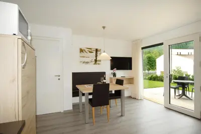 a kitchen and dining room with a table and chairs at Appartment Charly in Siusi