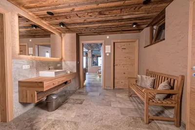 a bathroom with a sink and a wooden counter at Mountain Lodge Prennanger in Schenna