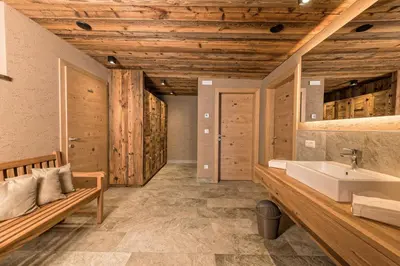 a bathroom with a sink and a wooden ceiling at Mountain Lodge Prennanger in Schenna