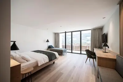a bedroom with a bed and a desk and a couch at Hotel Belvedere - Adults Only - 14 plus in Naturno
