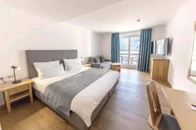 a living room with a bed and a table at Hotel Belvedere - Adults Only - 14 plus in Naturno